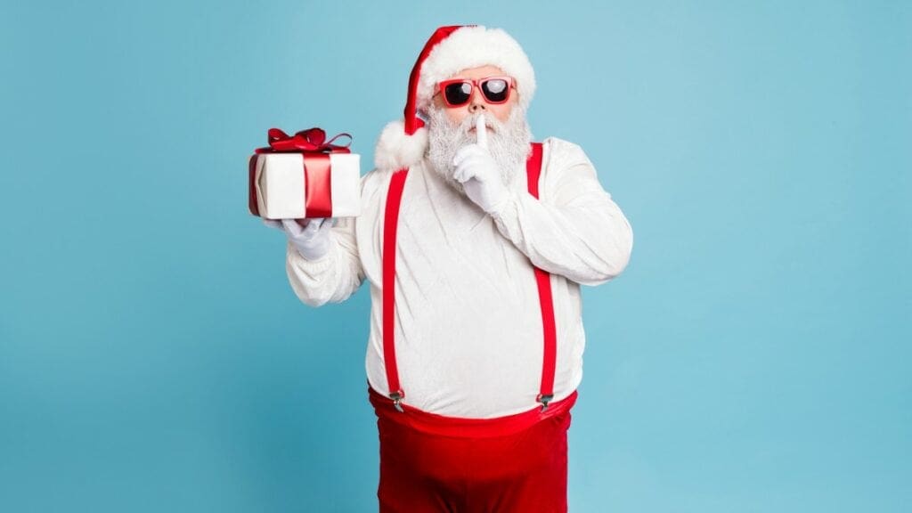 santa holding gift plain background