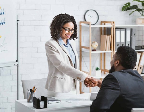 Black hiring manager shaking hands with successful vacancy candidate after work interview at office, copy space